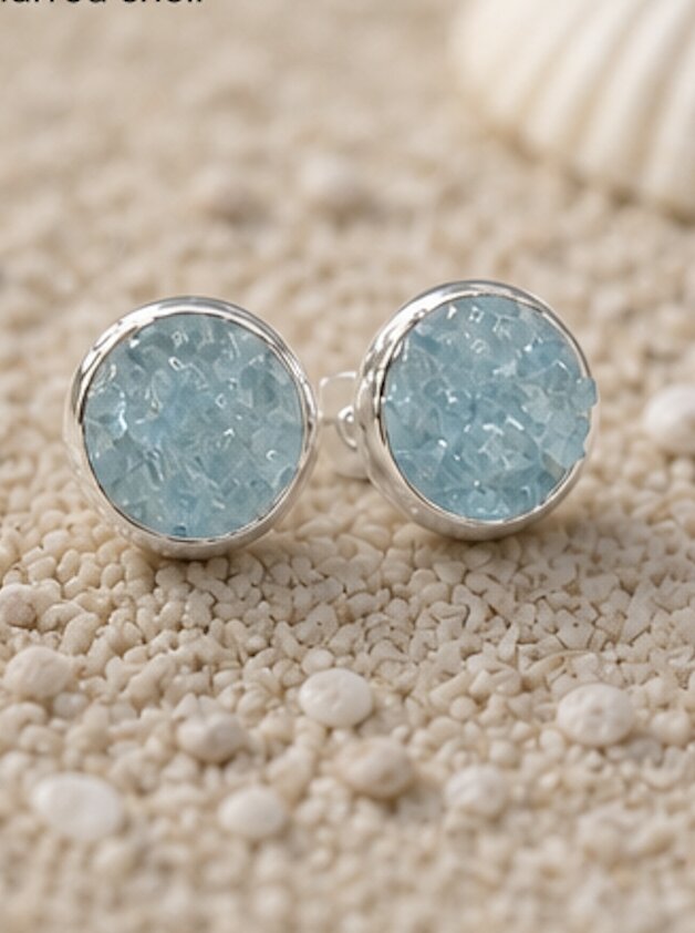 Amazonite stud on sand near shell